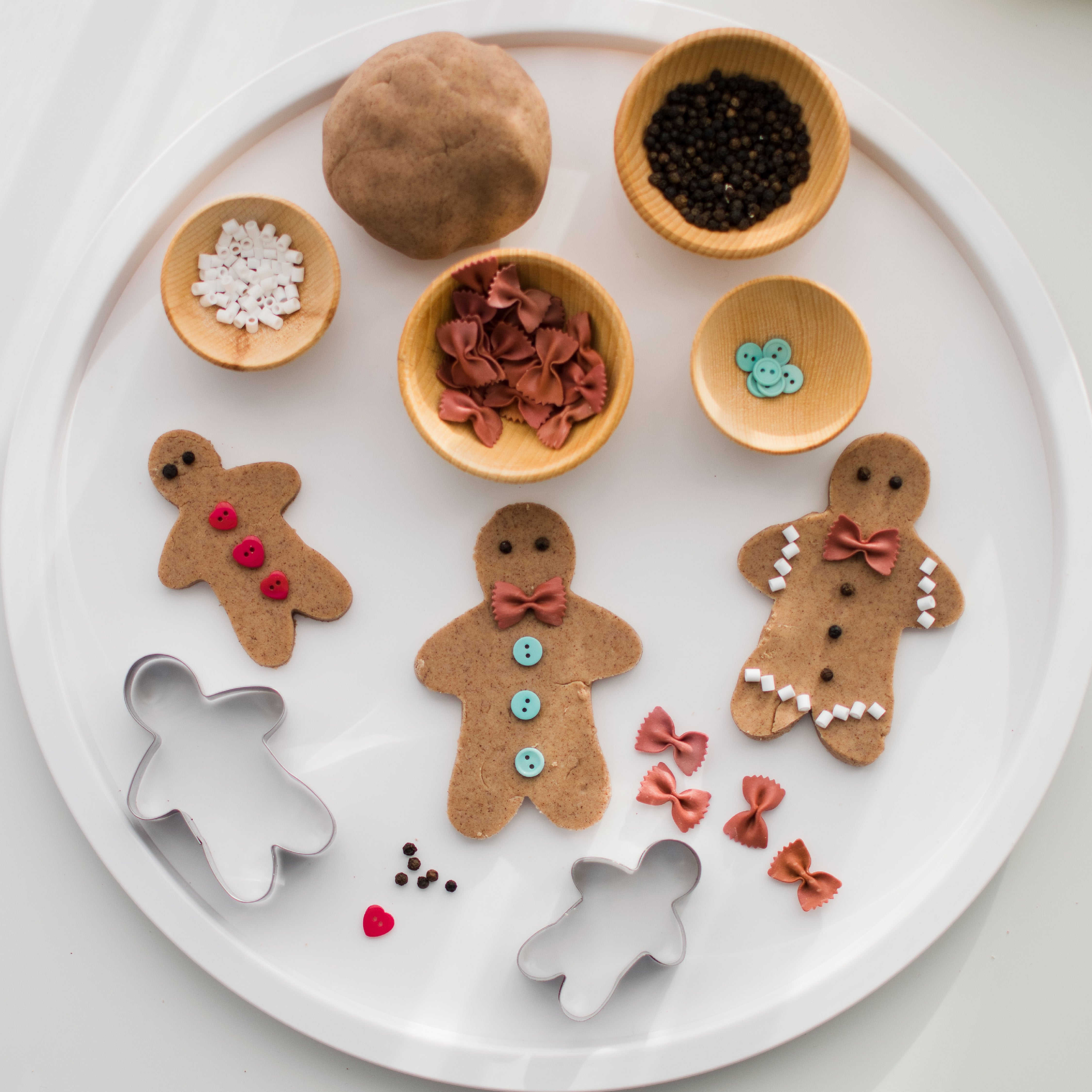 Gingerbread Playdough decorated with buttons and pasta 