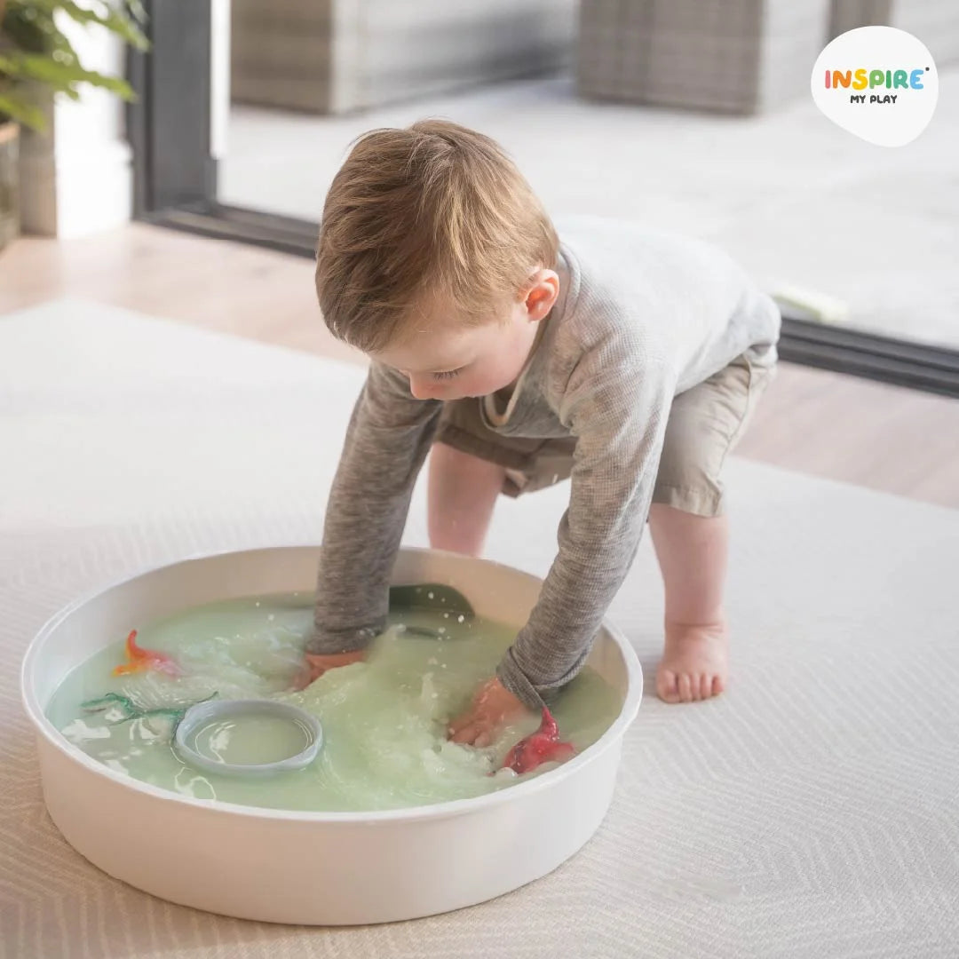 Young child playing with water in a PlayTRAY 