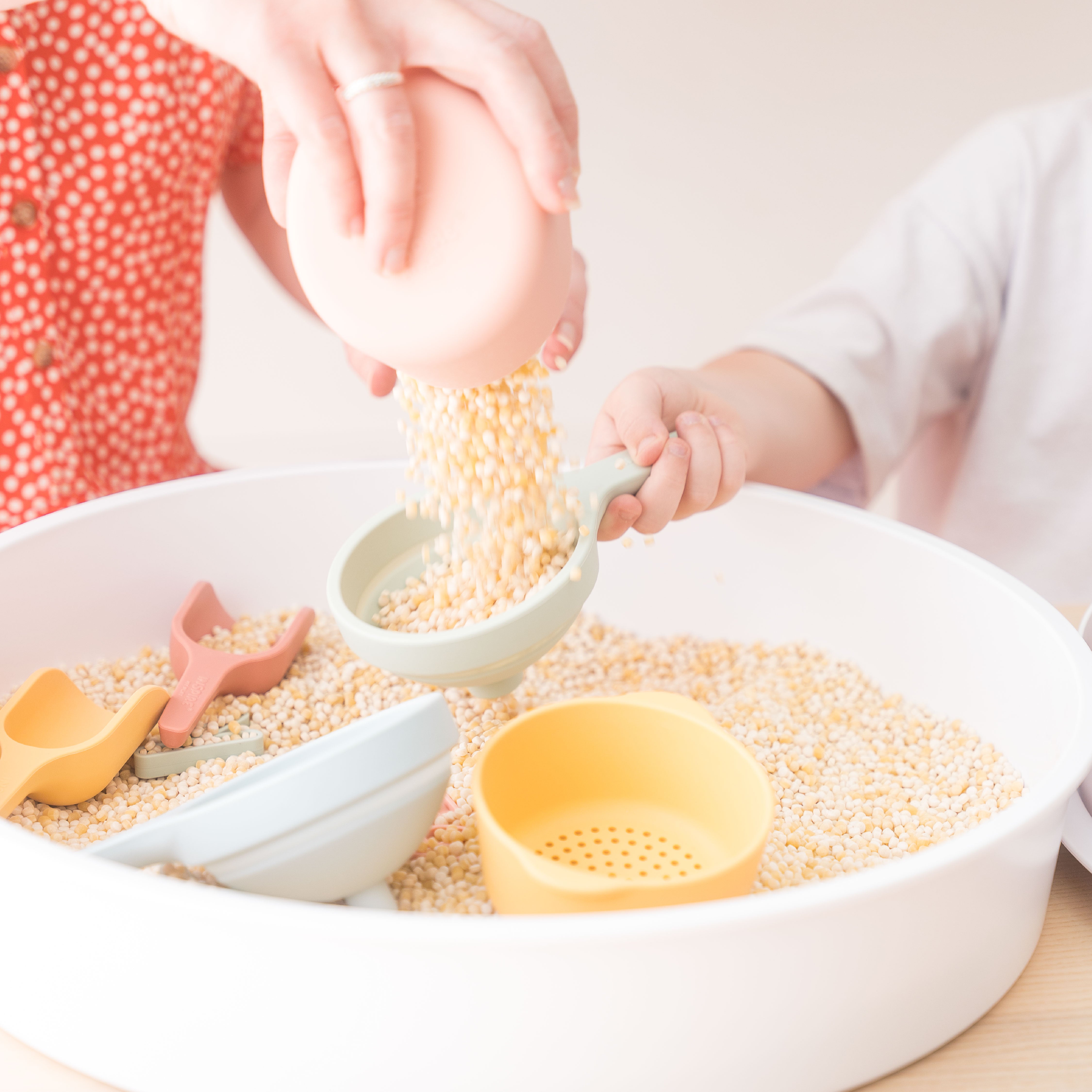 Pouring cous cous into a funnel