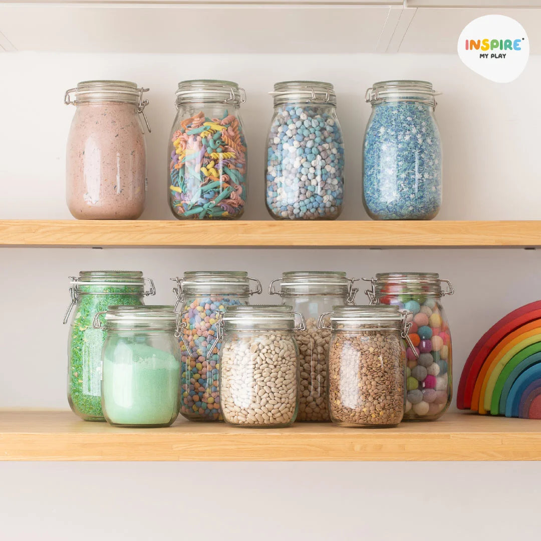 Glass storage jars on shelf containing sensory play bases 