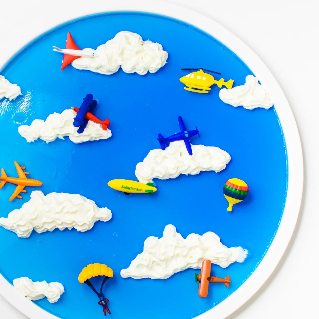 Blue jelly sky with cream clouds and toy planes