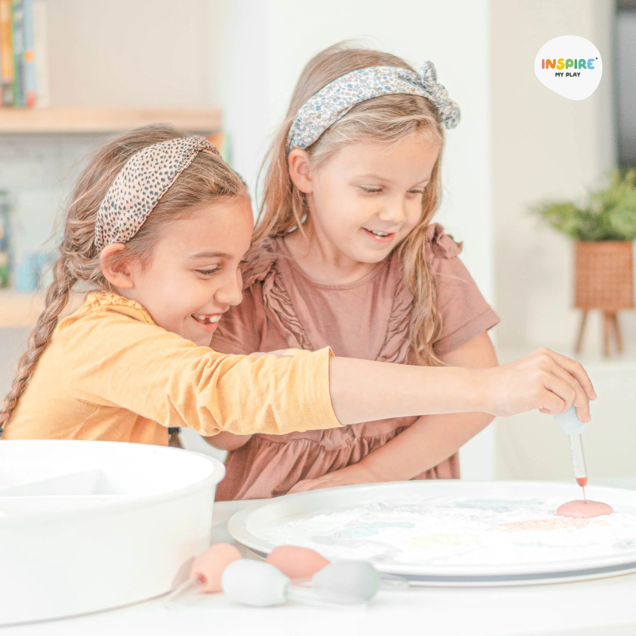 Two girls playing with a dropper and the PlayTRAY