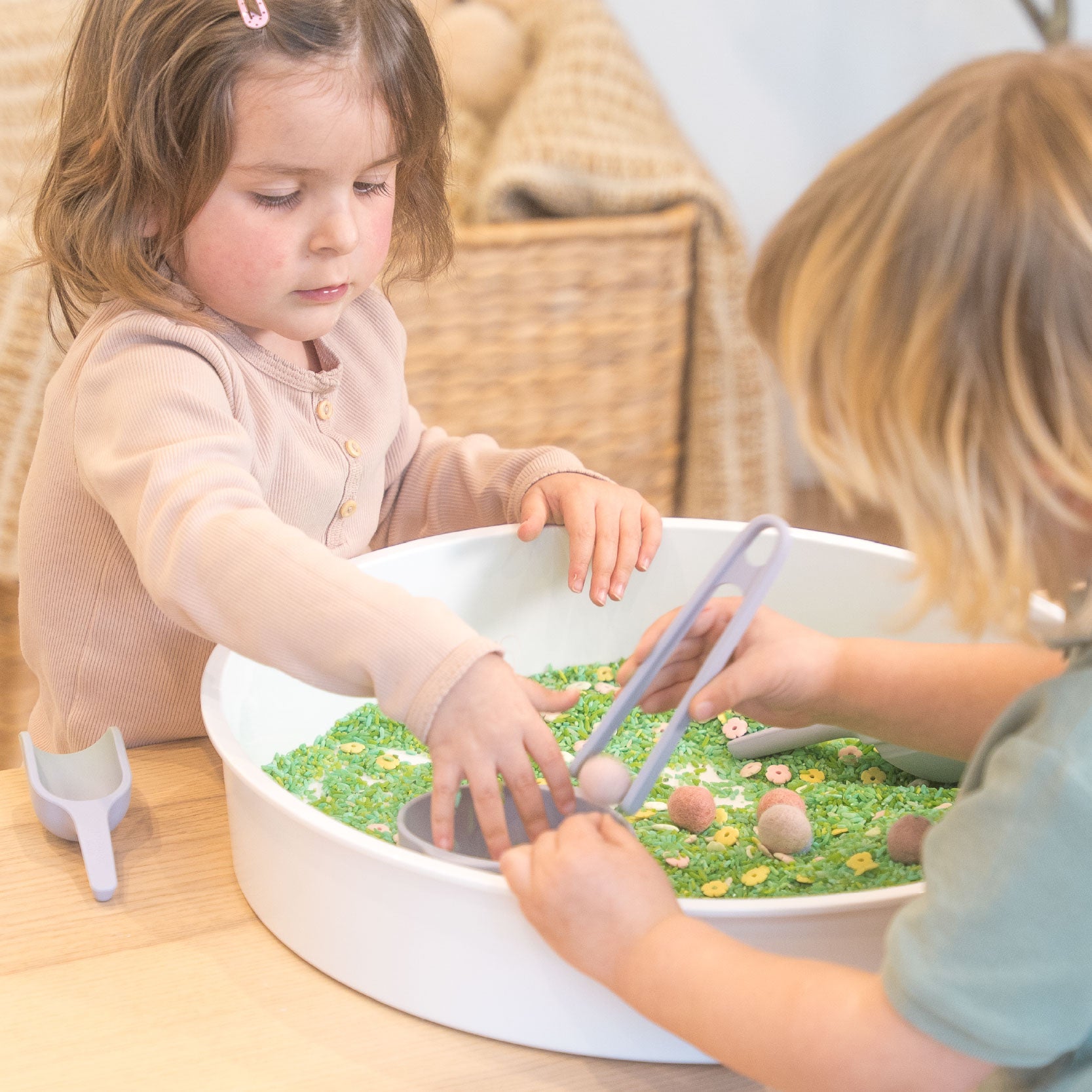 children playing with rice in PlayTRAY