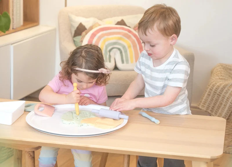 children playing with playdough tools in the lid of a PlayTRAY on a table