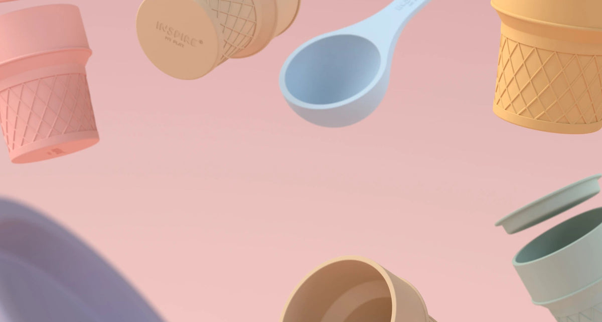 A pastel-coloured assortment of ice cream cone cups, and lids floating against a soft pink background.