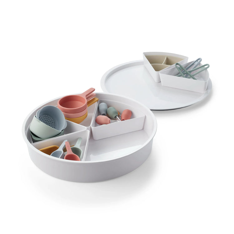 A children's sensory bin for sensory play filled with silicone sensory play tools including sensory bowls, funnels, scoops, droppers and tongs  on a clean white background.
