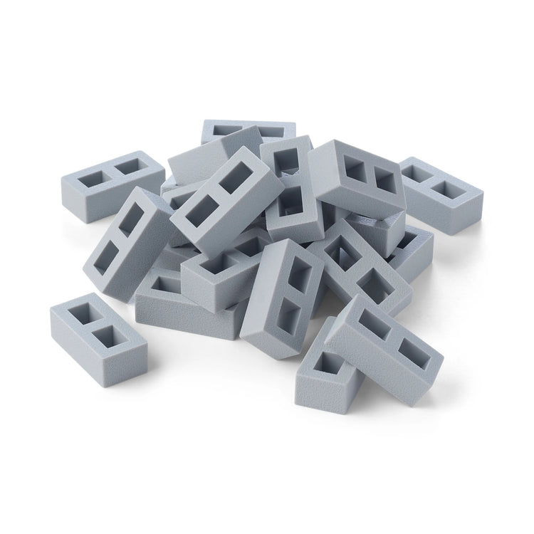 A pile of 25 small light grey silicone toy building blocks for children's sensory play and construction play, arranged on a plain white background.