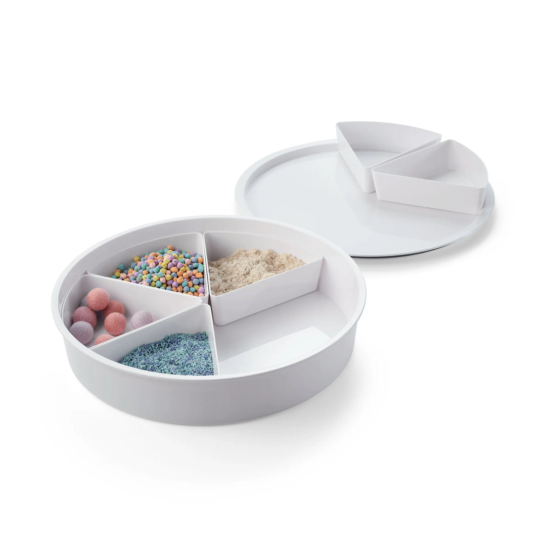 A white sensory bin with matching lid with six removable compartments filled with different sensory bases, shown on a clean white background. 