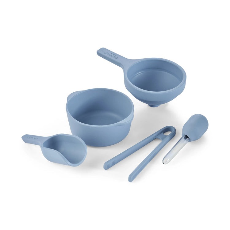 A set of silicone sensory play tools in a blue colour, including a bowl, scoop, funnel, tongs and dropper, arranged on a clean white background.