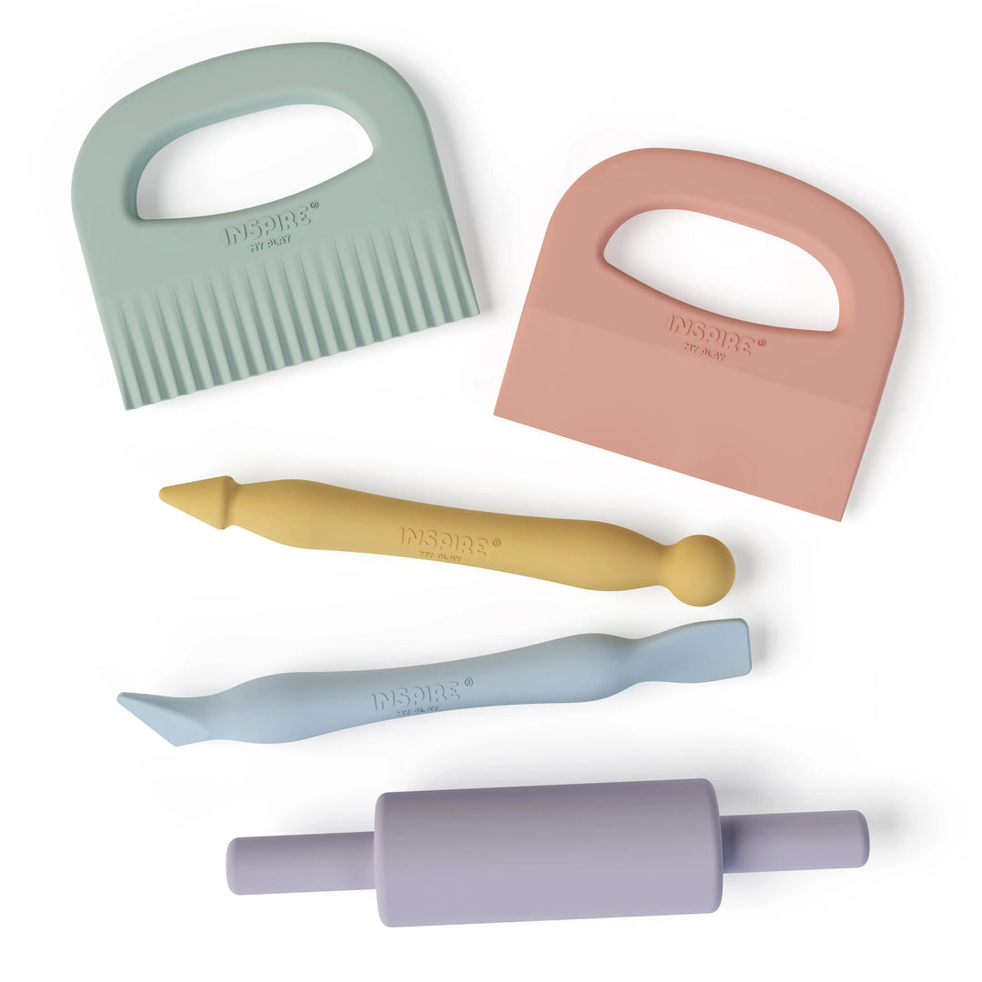 Set of colourful playdough tools including a rolling pin, crinkle cutter, straight cutter, stylus tool and sculpting tool on a white background.
