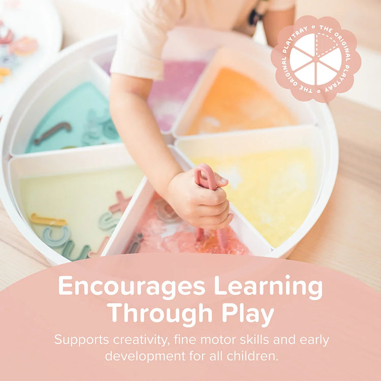 Child playing in the Inspire My Play sensory PlayTRAY with sensory tongs and silicone sensory play letters, promoting how sensory play encourages learning through play and builds fine motor skills.