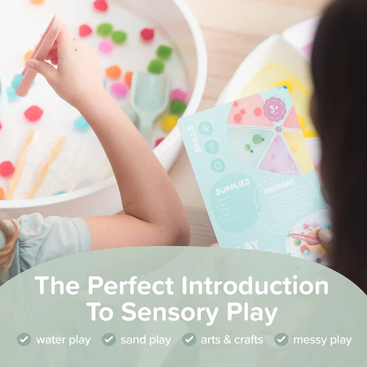 Child playing with sensory materials in the PlayTRAY and cards with recipes and ideas for sensory play activities.