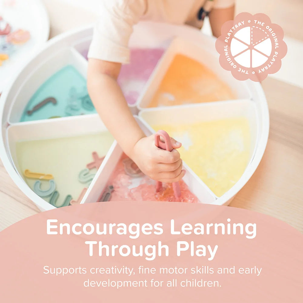 Child playing with colourful sensory tools in a sensory PlayTRAY, promoting learning through play.