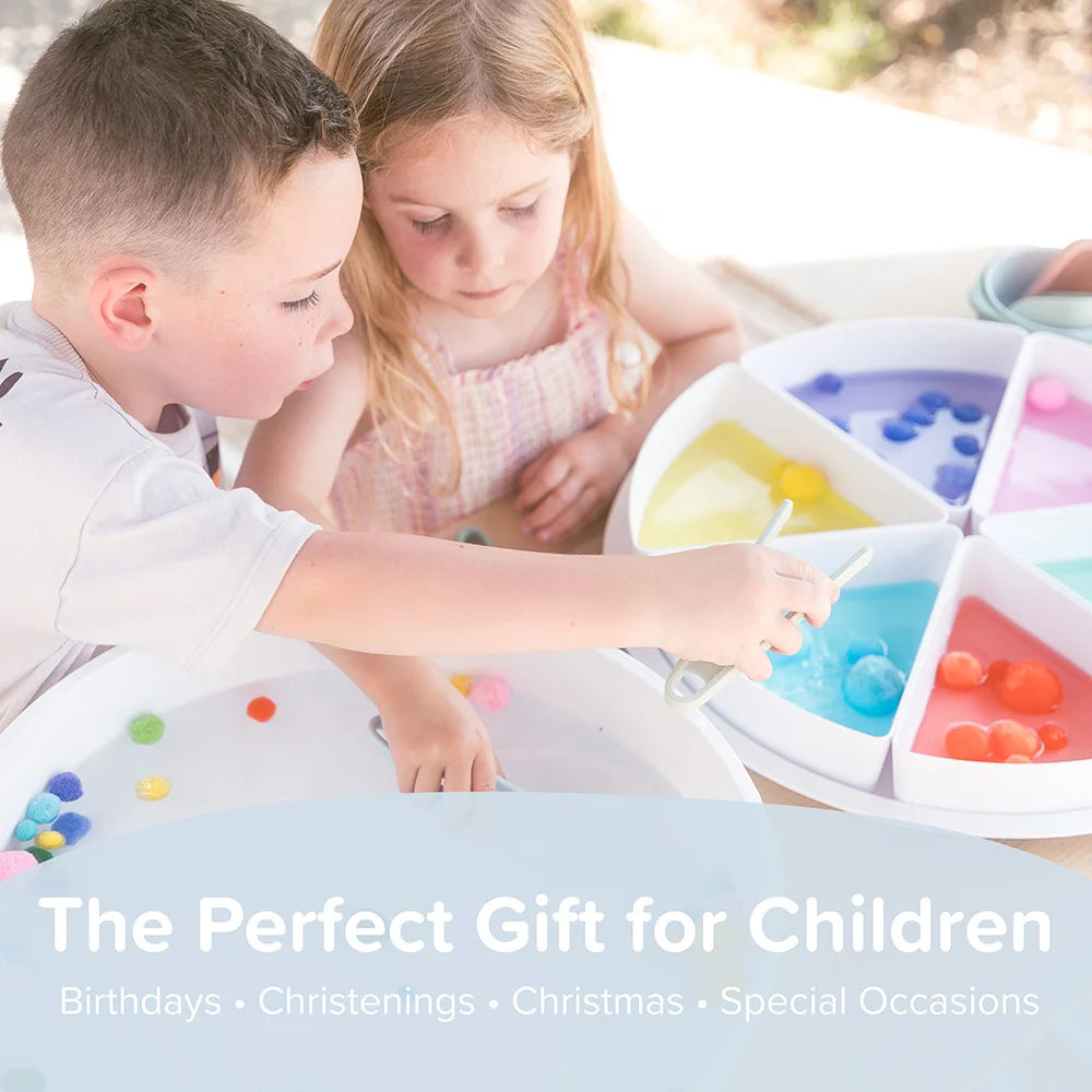 Two children sorting pom poms and transferring them with sensory tongs in a sensory PlayTRAY with lid for creative and messy play.