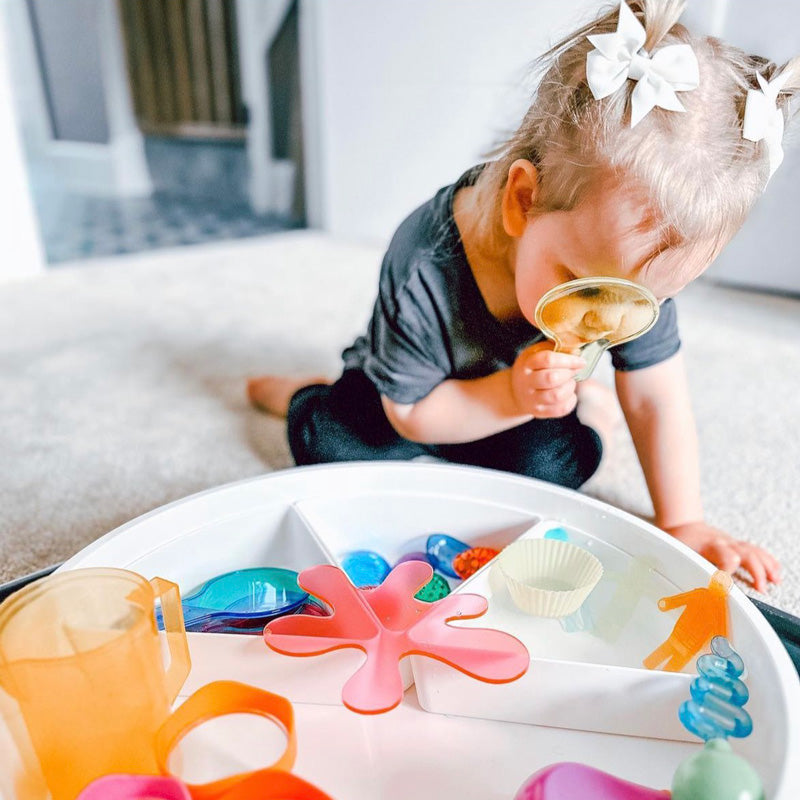 Young child exploring in the play tray 