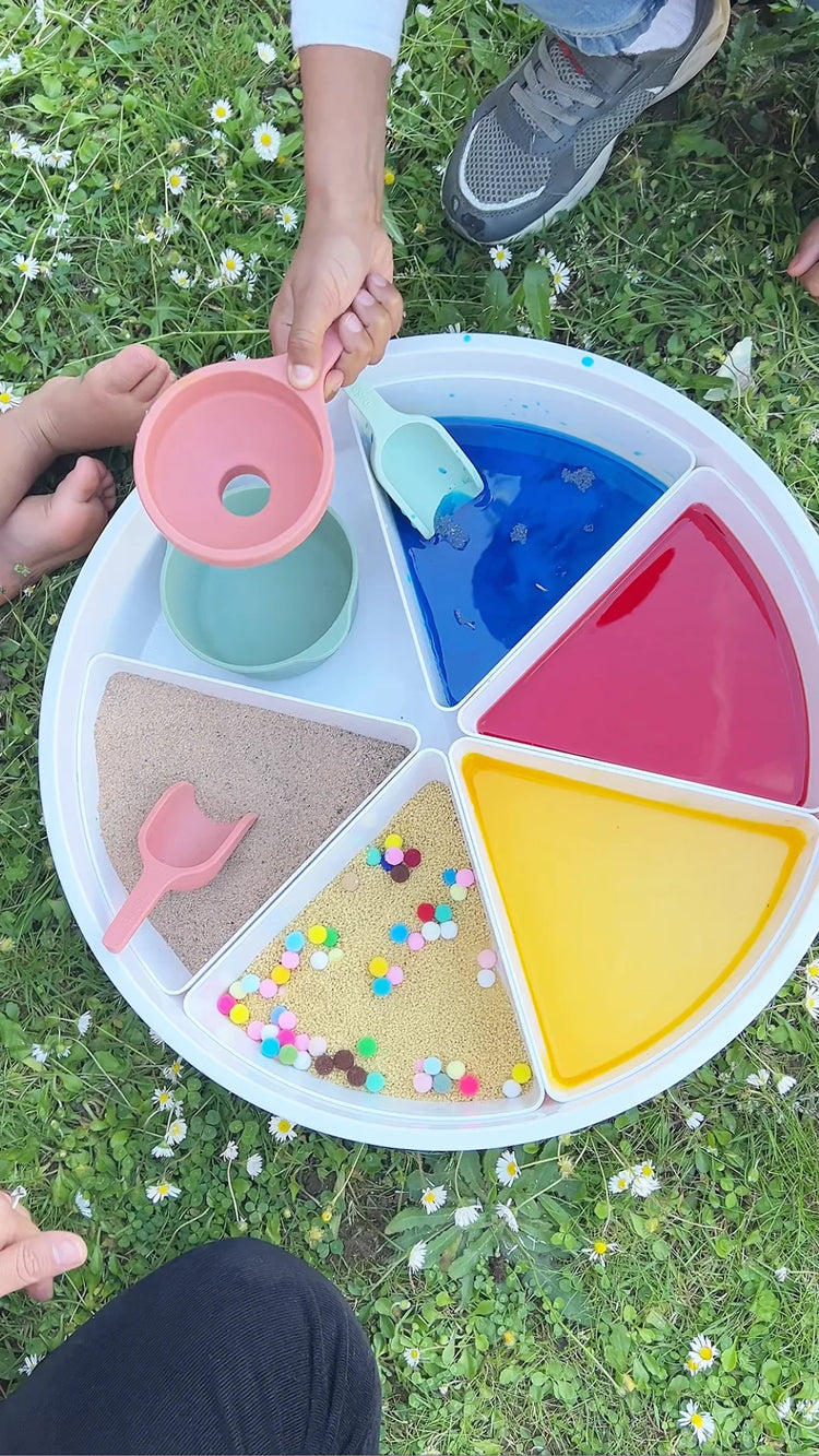 Kids outside playing with sensory play tray and droppers