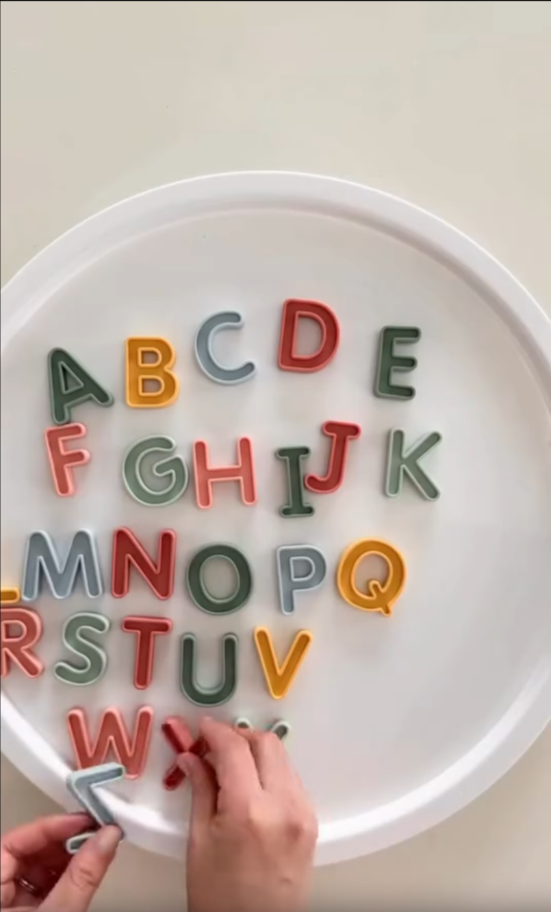 Silicone Uppercase Alphabet Letters being retrieved from a PlayTRAY filled with slime using sensory play tongs.