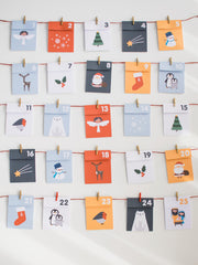 25 paper fold-up envelopes hung by mini clothes pegs on string and hung up on the wall