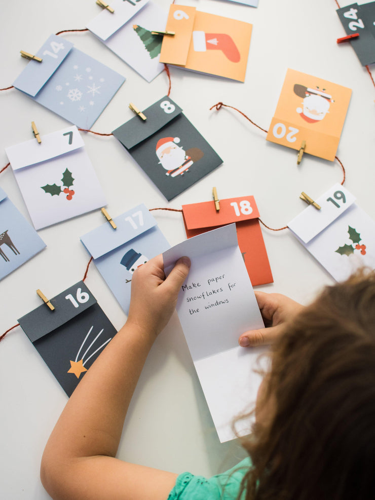 One advent paper envelope being unfolded to reveal the activity for the day
